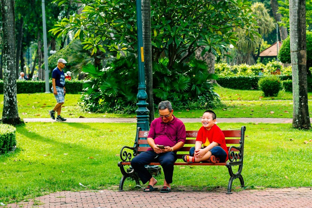 Happy Singaporean family relaxing together in a park